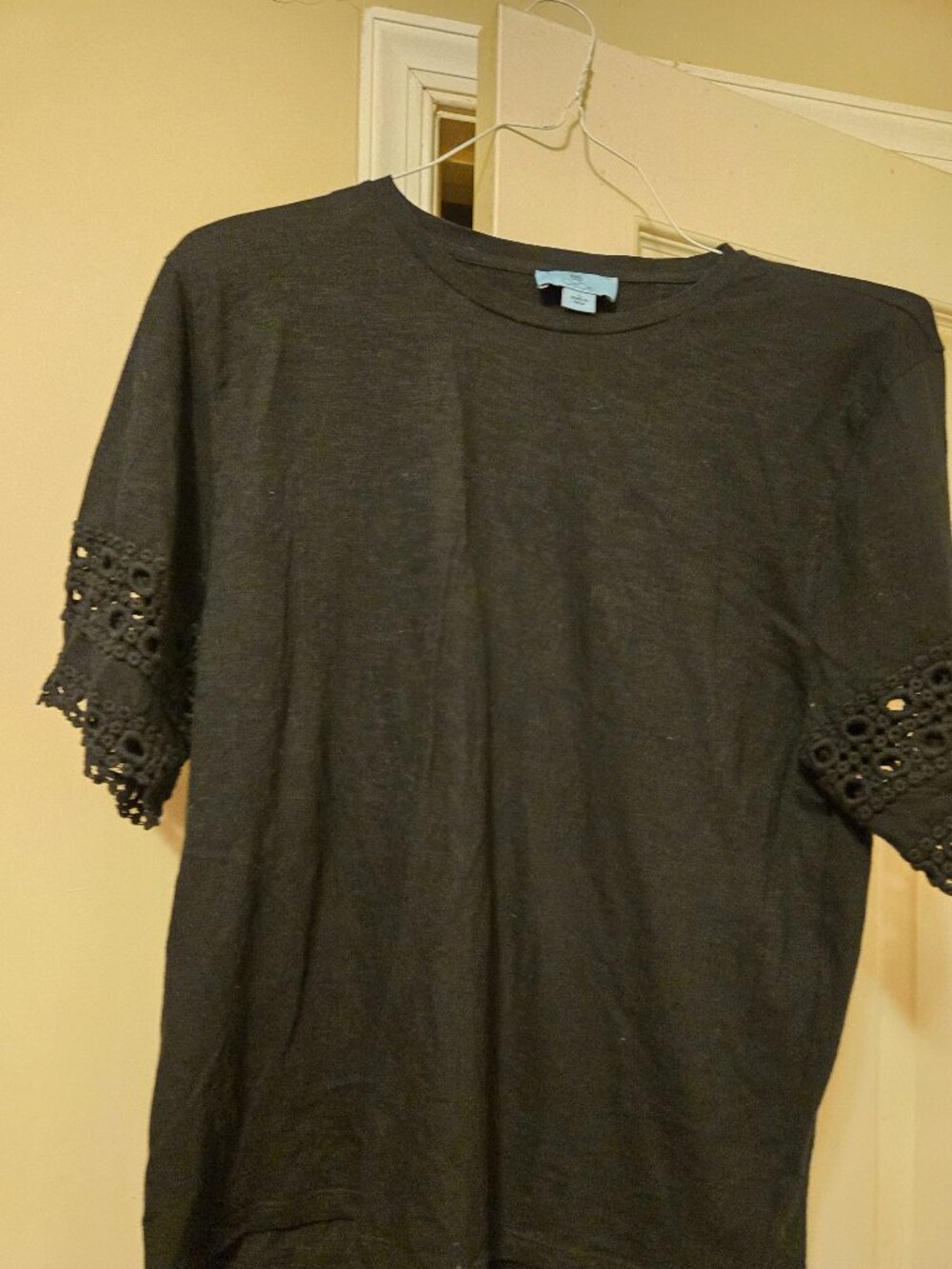 Cece L black tee , short sleeved with black lace hem on sleeves